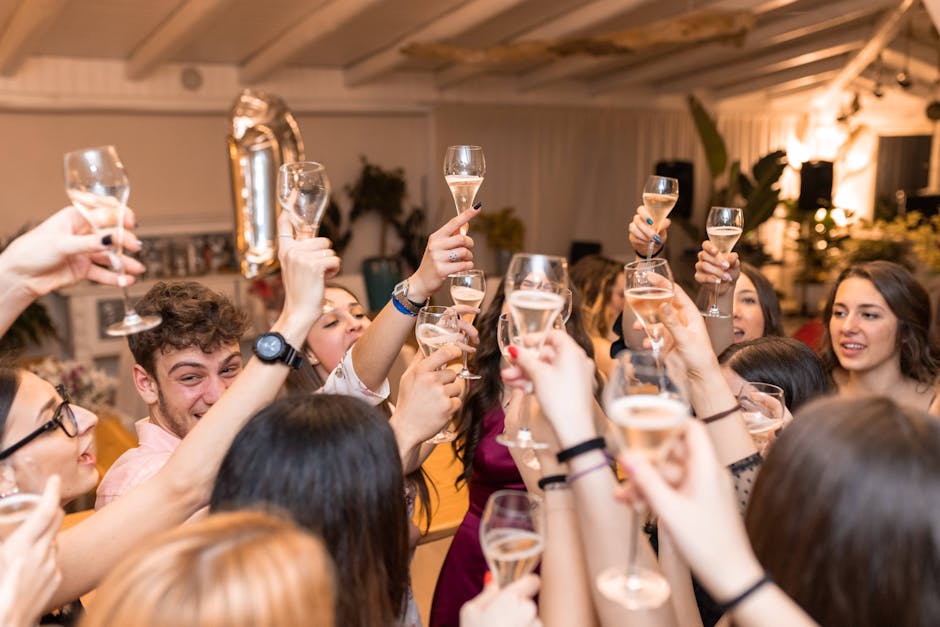 A lively indoor celebration with friends raising glasses in a cheerful toast.