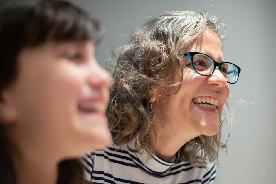 Close-up of two women sharing a joyful moment indoors, captured in Portugal.
