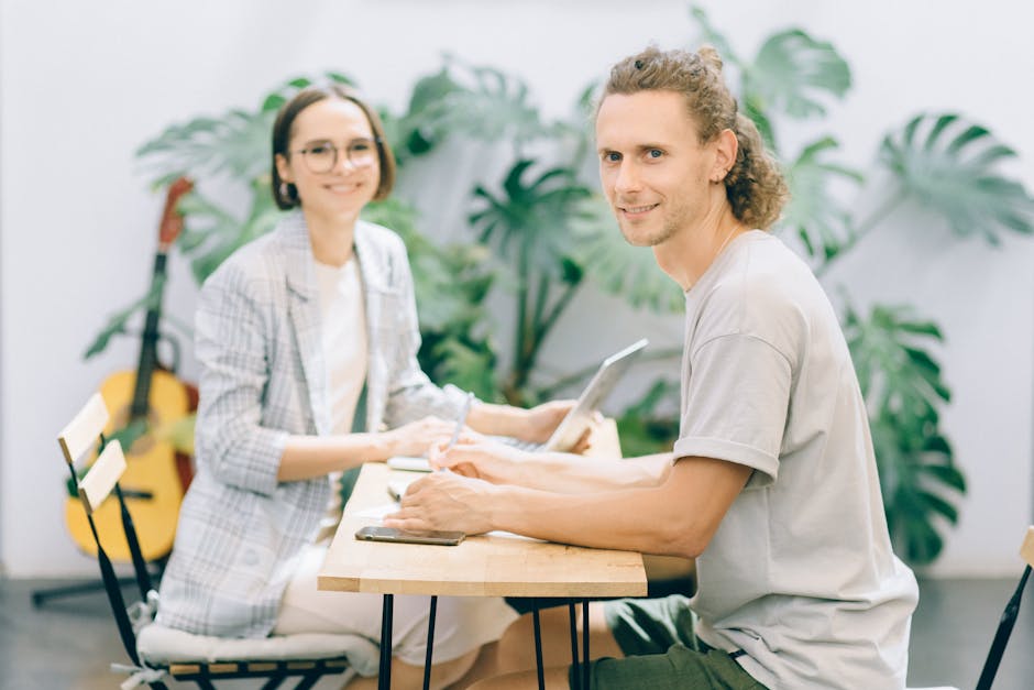 Two professionals collaborating in a stylish office setting.